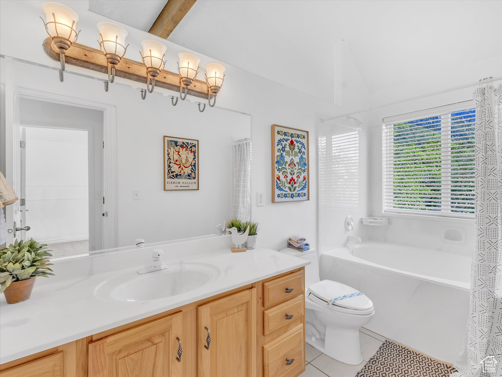 Full bath with toilet, vanity, tile patterned flooring, and a bathtub