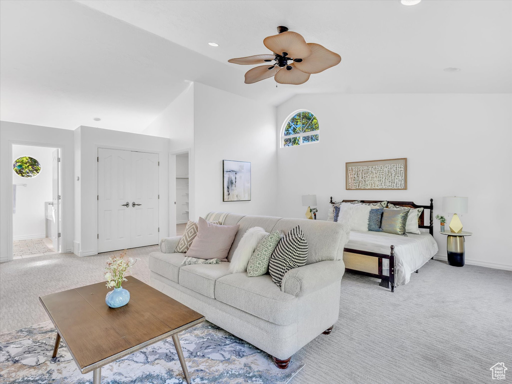 Living area featuring light carpet, vaulted ceiling, ceiling fan, baseboards, and recessed lighting