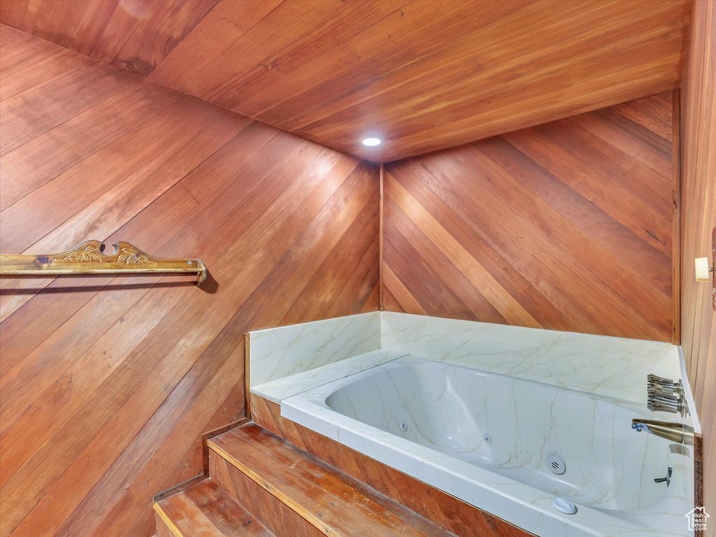 Full bathroom featuring wooden ceiling and a whirlpool tub