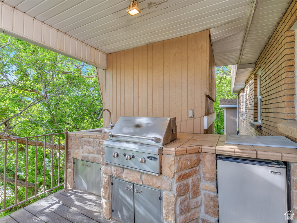 View of patio featuring area for grilling and a sink