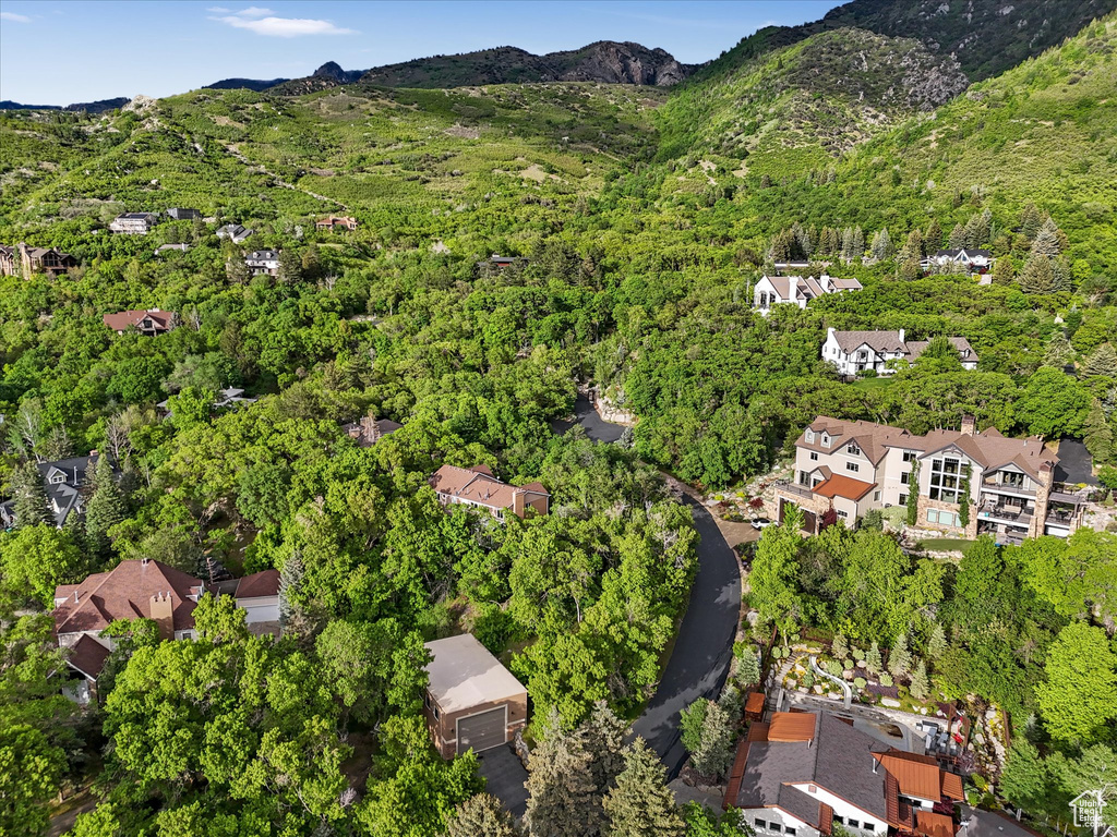 Aerial view of property and surrounding area with a mountain backdrop