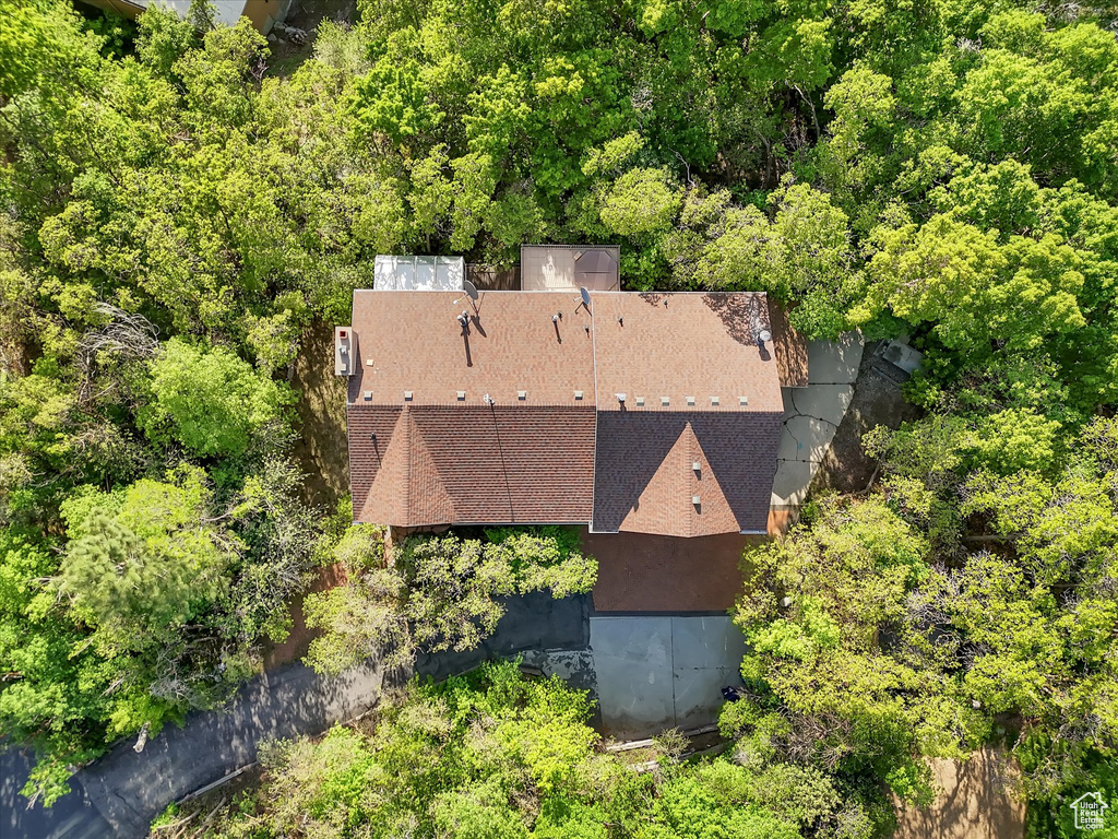 View from above of property featuring a heavily wooded area