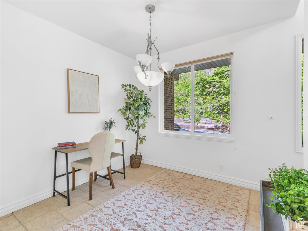 Tiled office with a chandelier and baseboards
