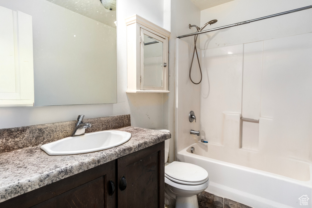 Full bathroom featuring toilet, shower / bathtub combination, and vanity