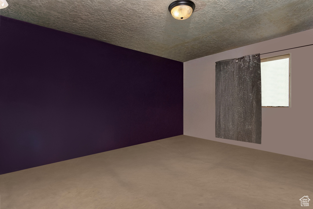 Spare room with carpet floors and a textured ceiling