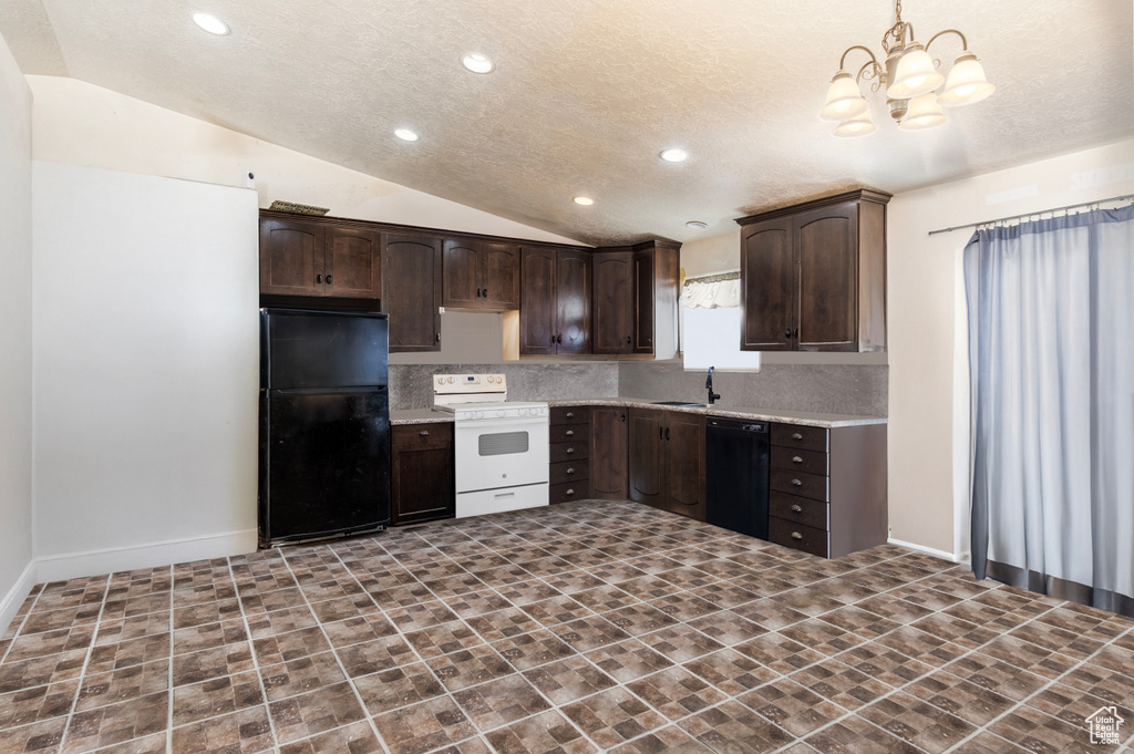 Kitchen with black appliances, dark brown cabinets, a sink, vaulted ceiling, and a chandelier