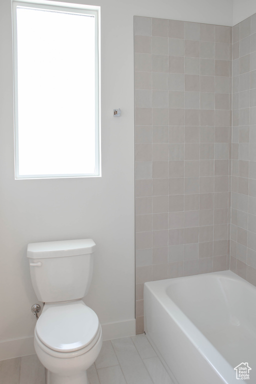 Bathroom with baseboards, tile patterned flooring, and toilet
