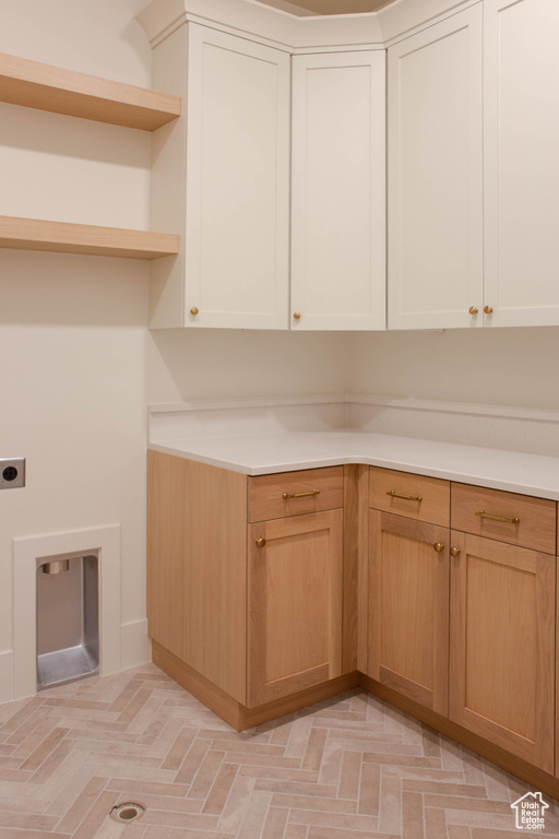 Laundry area with cabinet space and hookup for an electric dryer