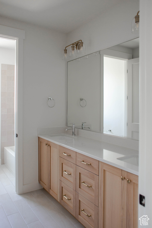 Full bath featuring double vanity, tile patterned flooring, a bath, and a shower
