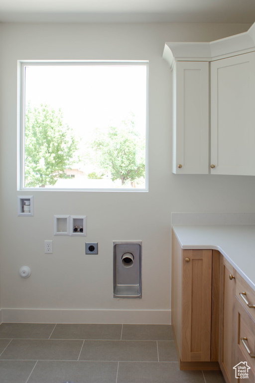 Washroom featuring electric dryer hookup, washer hookup, baseboards, tile patterned flooring, and gas dryer hookup