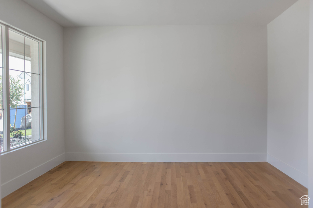 Unfurnished room with baseboards and light wood finished floors