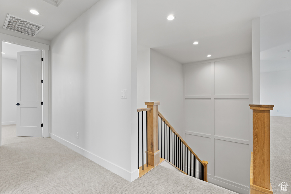 Corridor featuring an upstairs landing, carpet flooring, recessed lighting, and baseboards