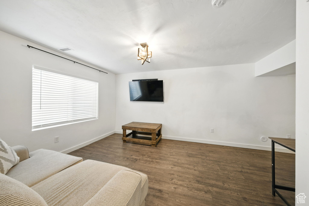 Living area with baseboards and wood finished floors
