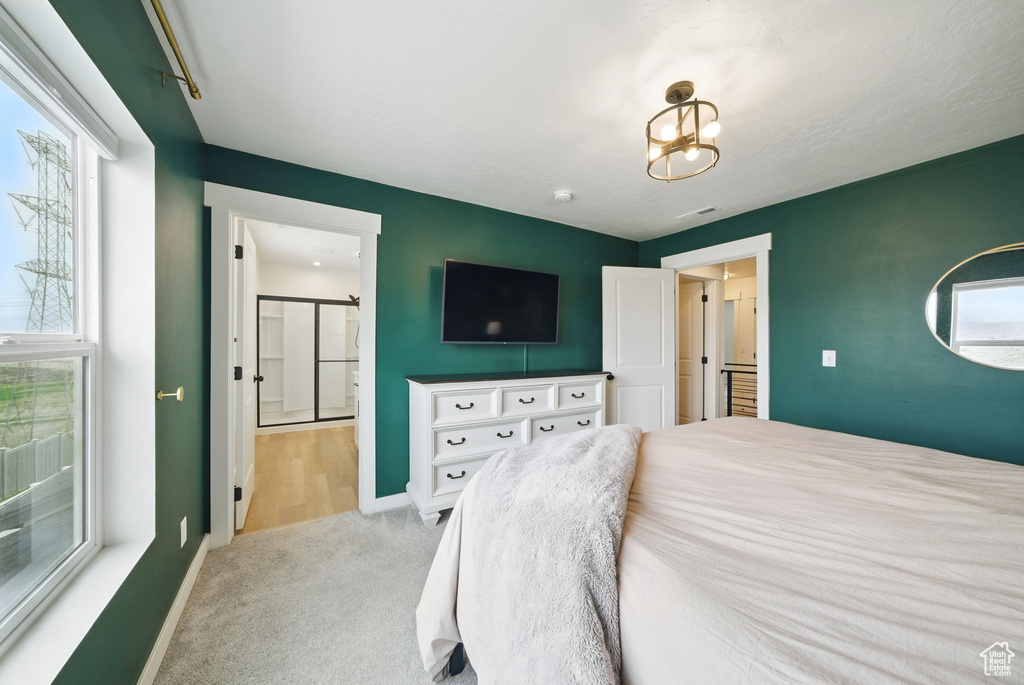 Bedroom featuring carpet, baseboards, and ensuite bathroom