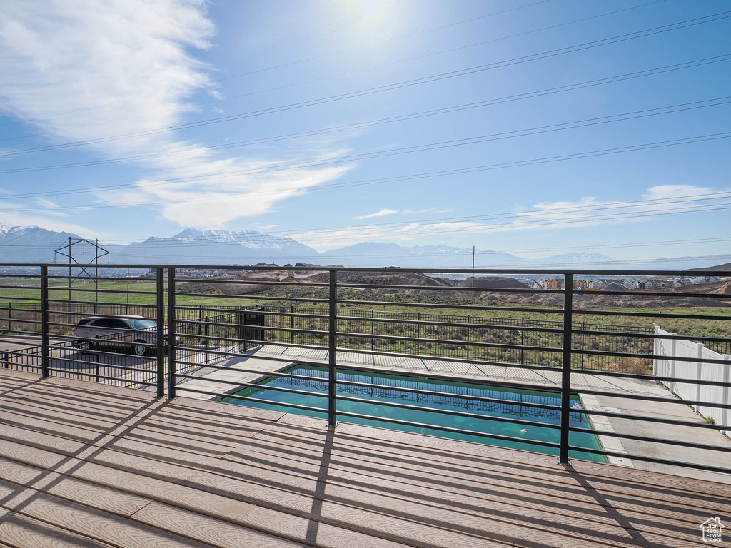 View of pool with fence and a mountain view