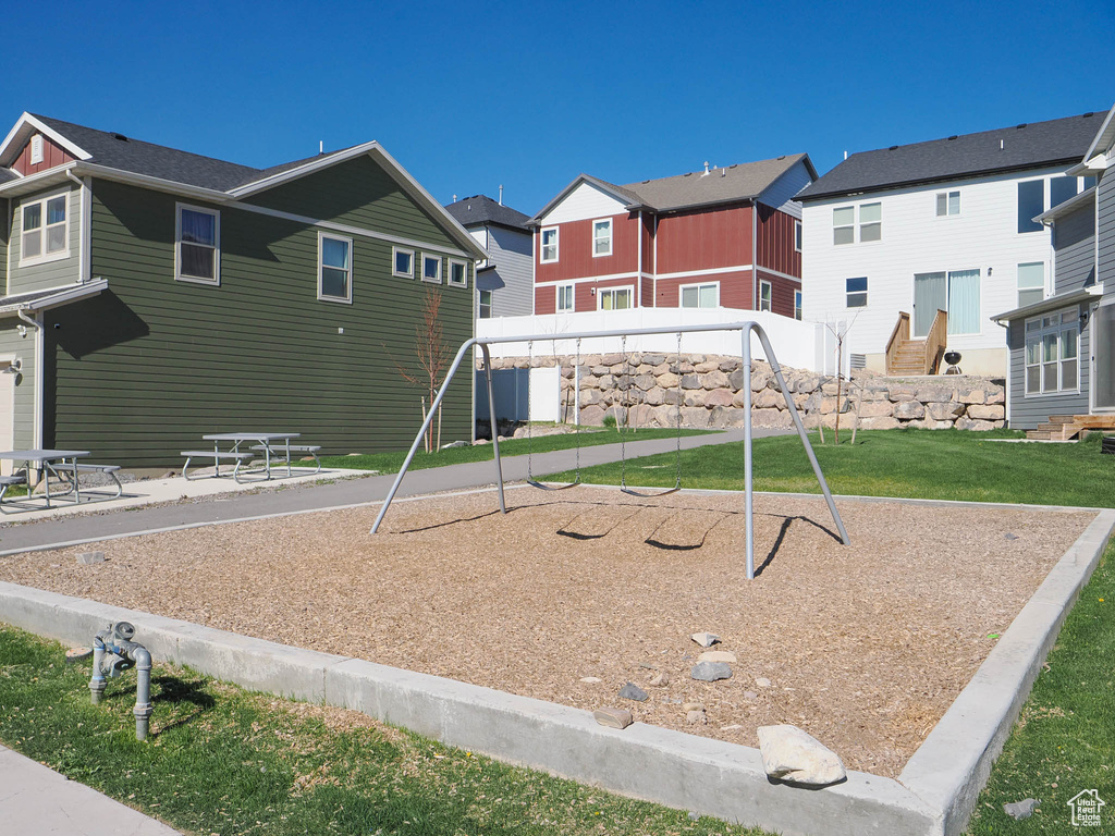 Community play area featuring a residential view and a yard