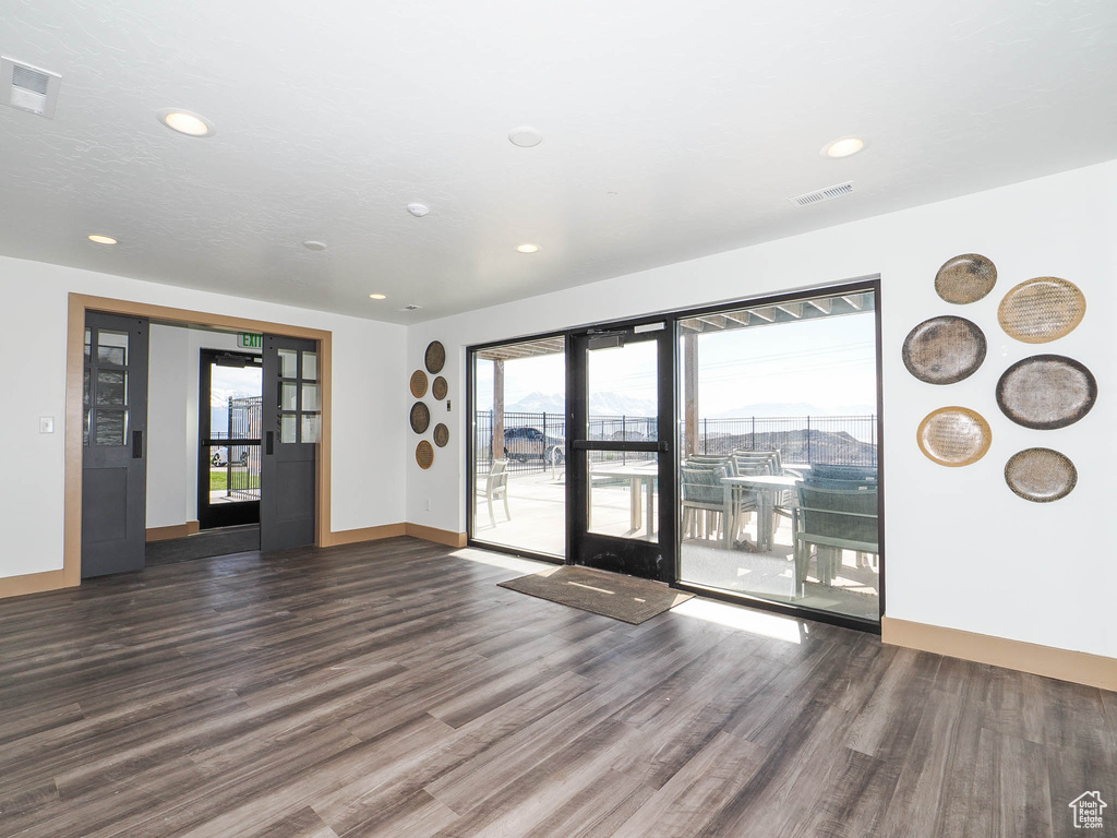 Spare room featuring wood finished floors, recessed lighting, and baseboards