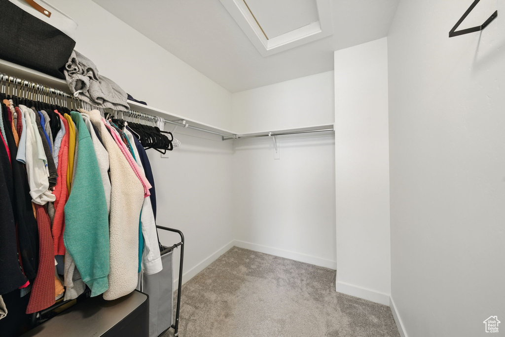 Spacious closet with carpet and attic access