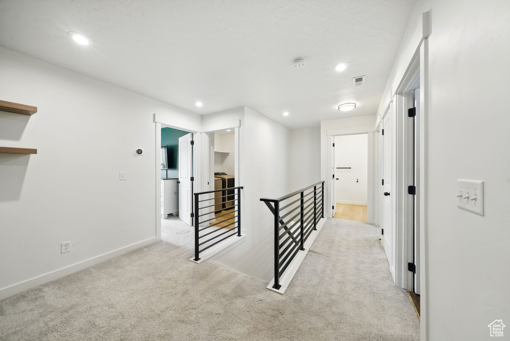 Hallway featuring an upstairs landing, carpet floors, recessed lighting, and baseboards