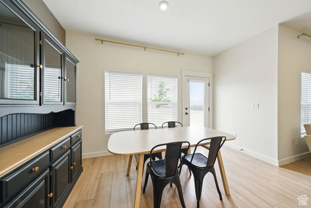Dining space with light wood-type flooring and baseboards