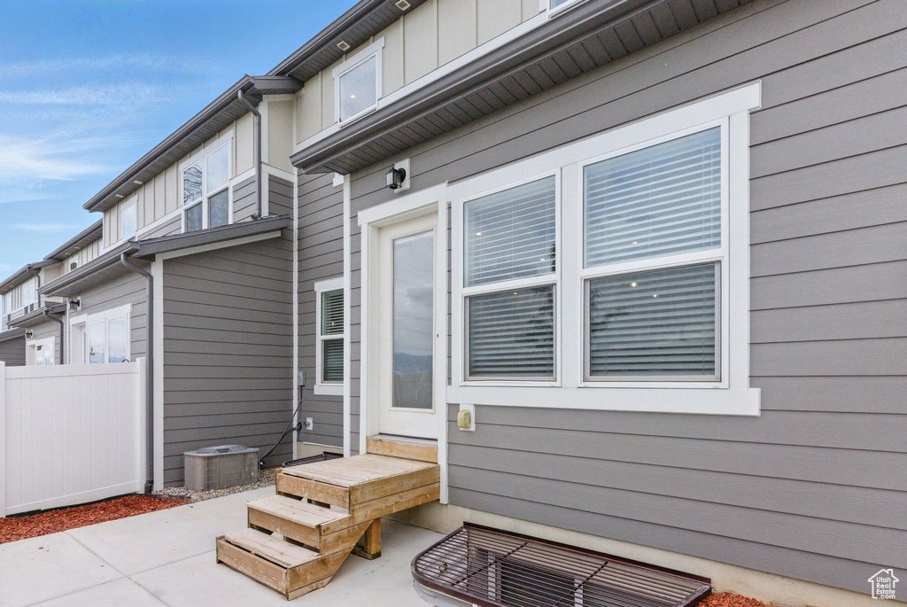 View of patio with fence and central AC