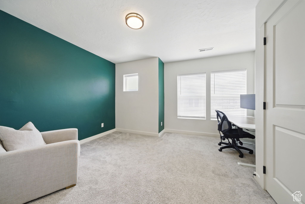 Carpeted office space with baseboards