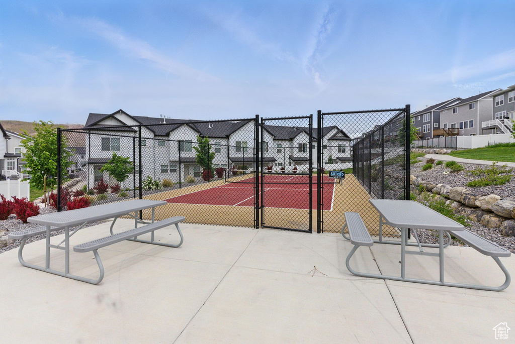 View of home\\\\\\\\\\\\\\\'s community featuring a tennis court, a residential view, fence, and a gate