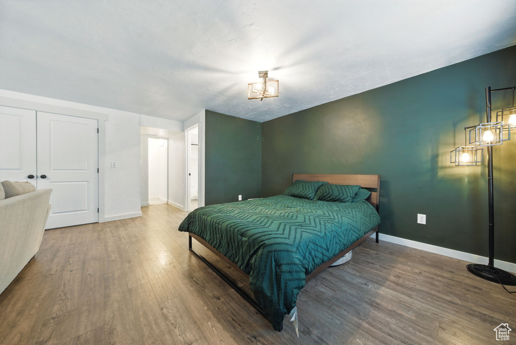 Bedroom with wood finished floors and baseboards