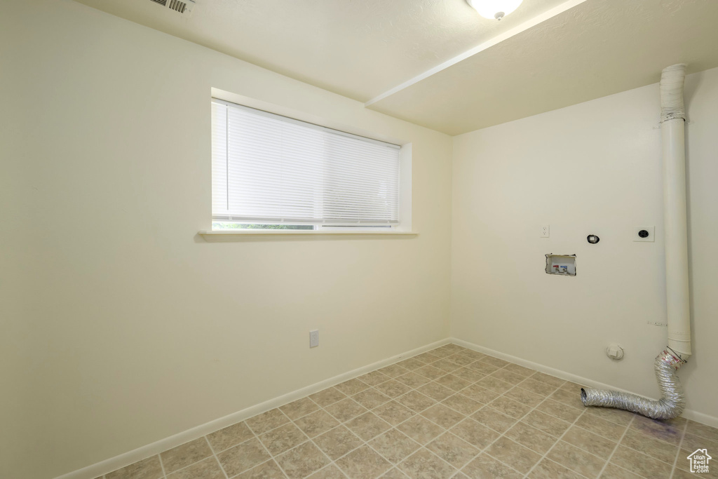 Clothes washing area with hookup for an electric dryer, washer hookup, baseboards, and hookup for a gas dryer