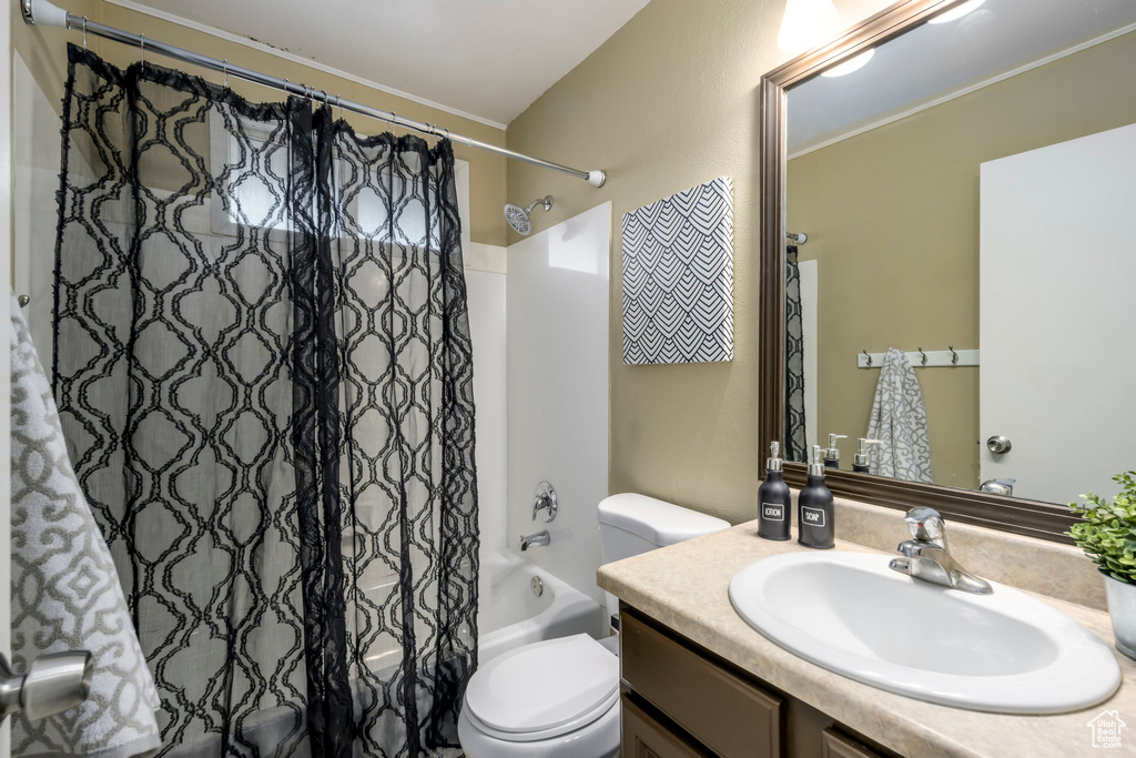 Full bathroom with shower / bath combo, toilet, and vanity