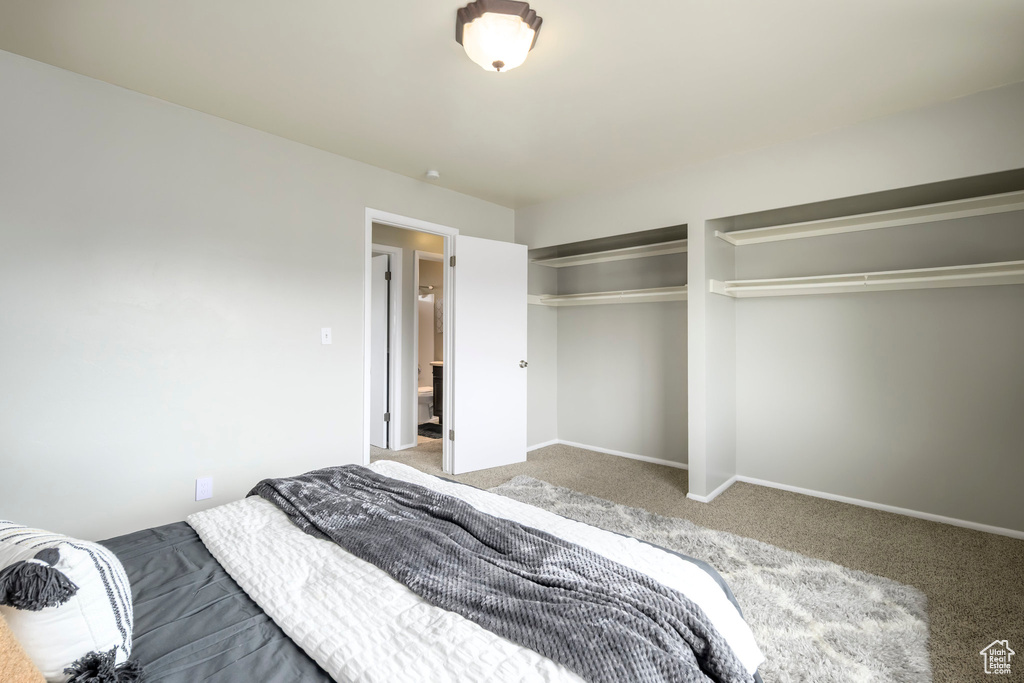 Bedroom with carpet floors and baseboards