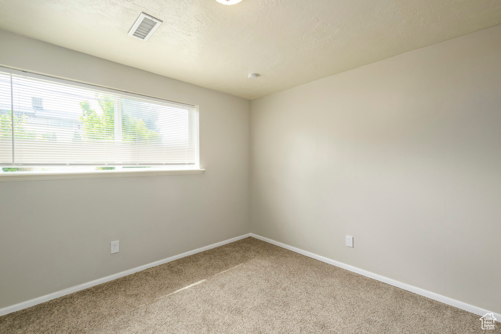 Spare room with carpet flooring and baseboards