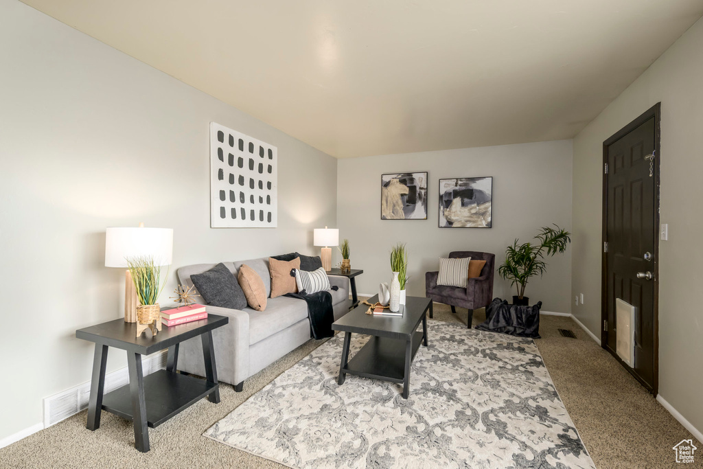 Living room with carpet flooring and baseboards
