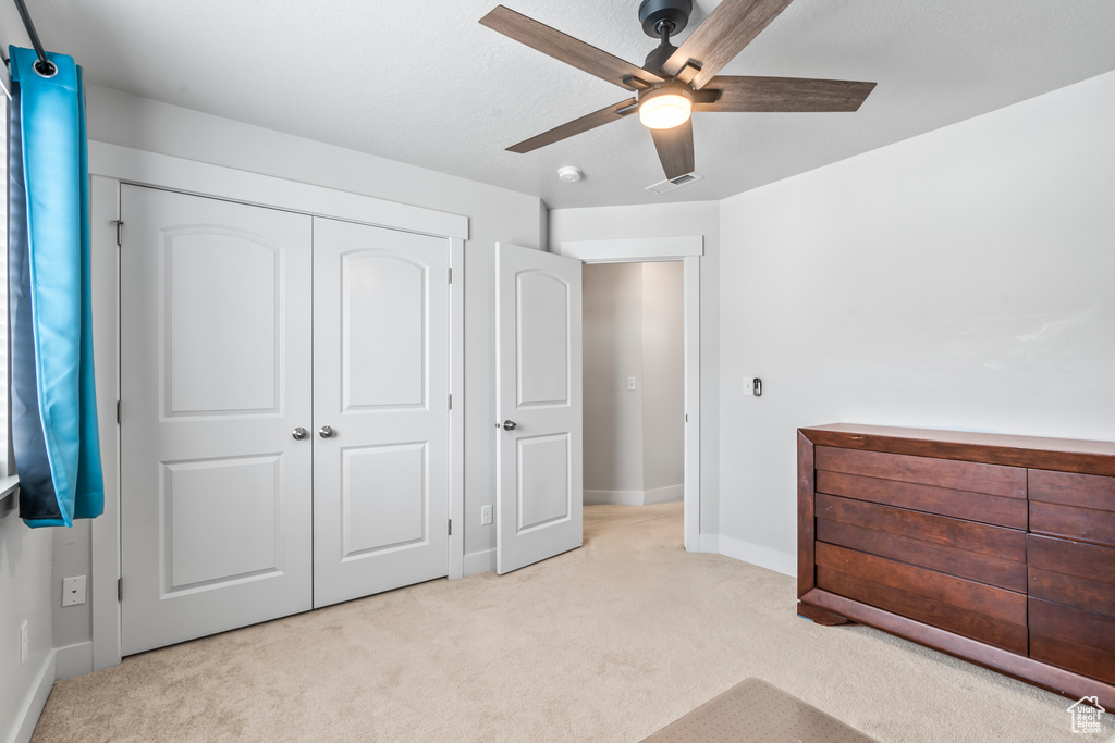 Bedroom featuring carpet flooring, baseboards, a closet, and a ceiling fan