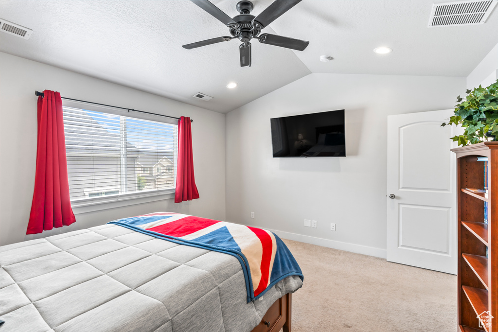 Carpeted bedroom featuring vaulted ceiling, recessed lighting, baseboards, and a ceiling fan