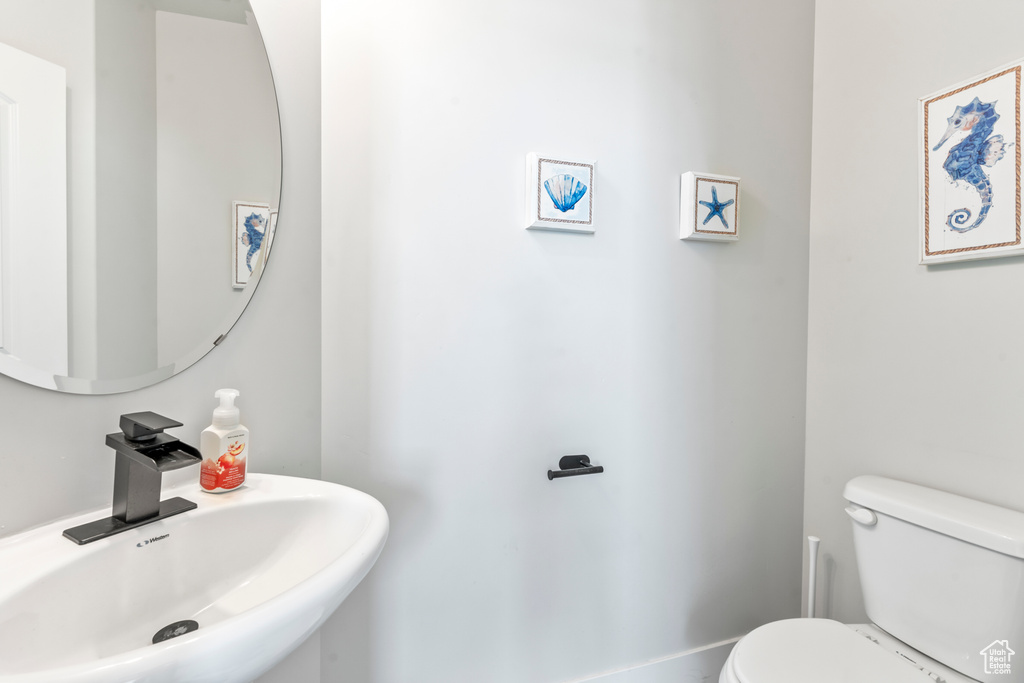 Half bathroom featuring a sink and toilet