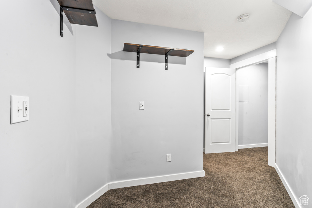 Hall featuring carpet flooring and baseboards