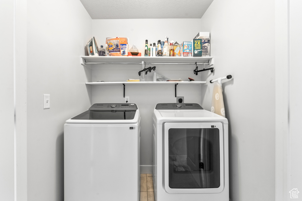 Clothes washing area featuring washing machine and clothes dryer