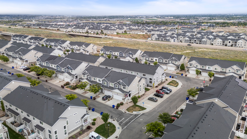 Aerial view of property and surrounding area with nearby suburban area