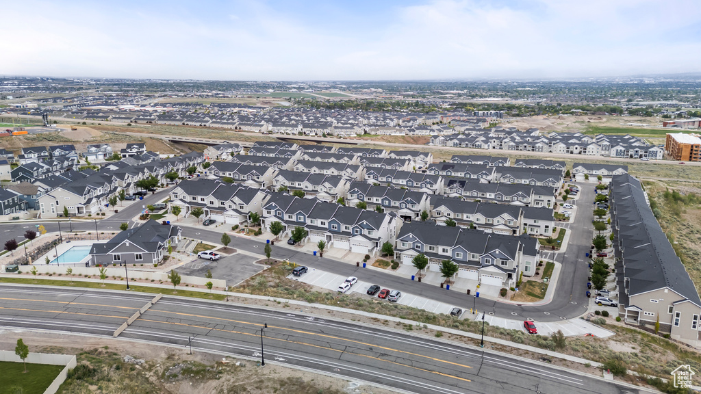 Aerial view of property and surrounding area with nearby suburban area
