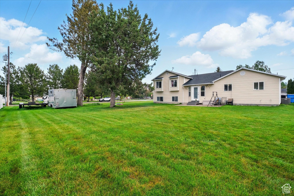 View of grassy yard with a patio