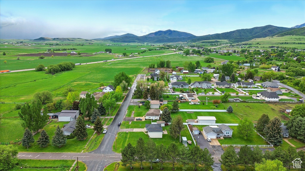 Overview of rural landscape featuring a mountainous background and nearby suburban area