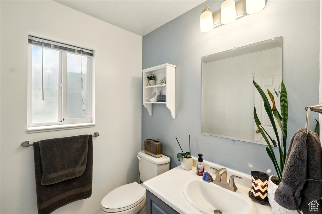 Half bath featuring toilet and vanity