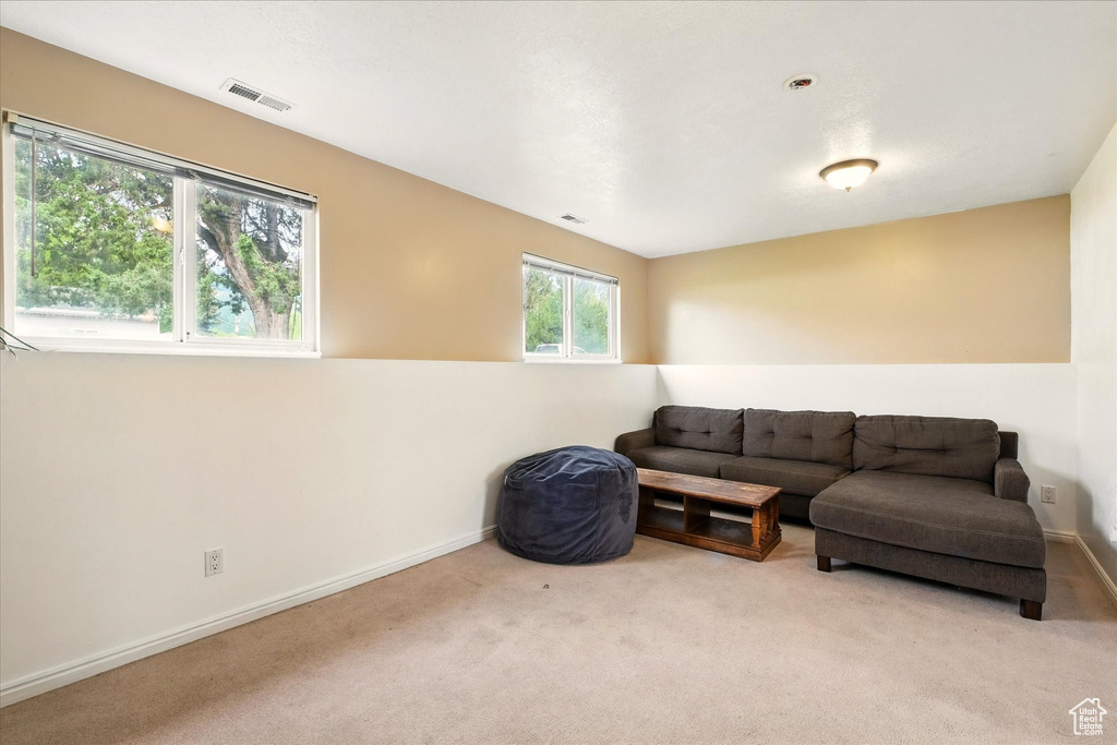 Carpeted living area featuring baseboards