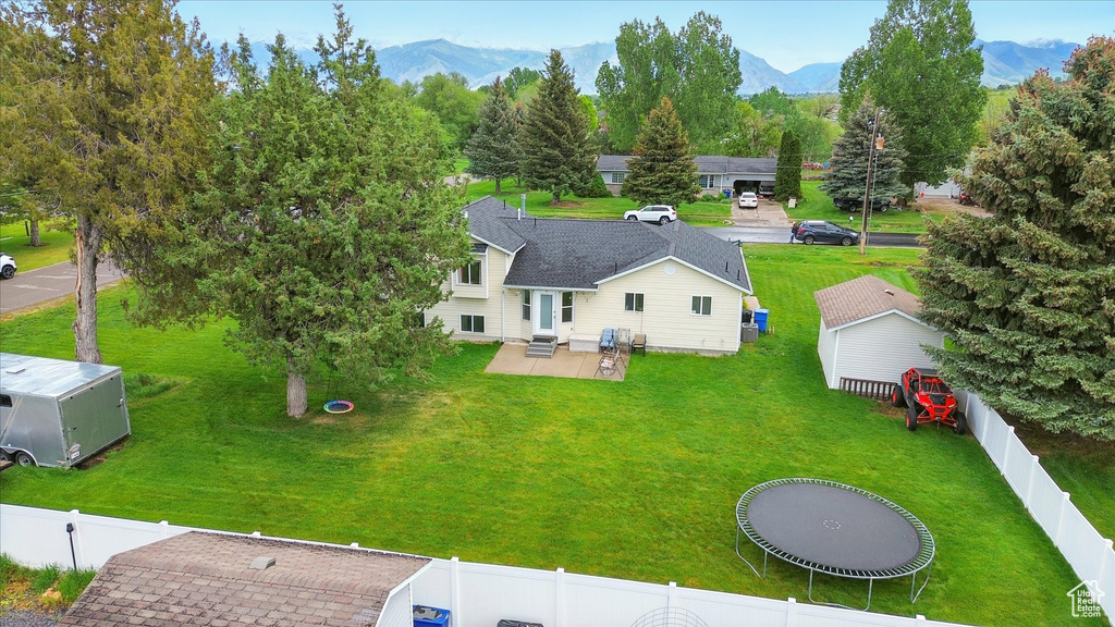Aerial view of property and surrounding area with a mountainous background