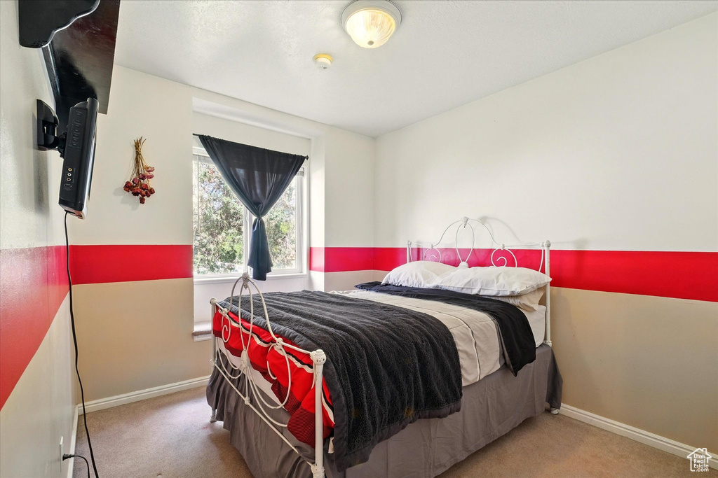 Bedroom with carpet floors and baseboards