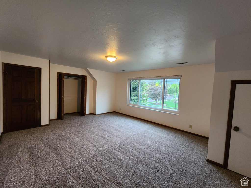 Unfurnished bedroom featuring carpet flooring and baseboards