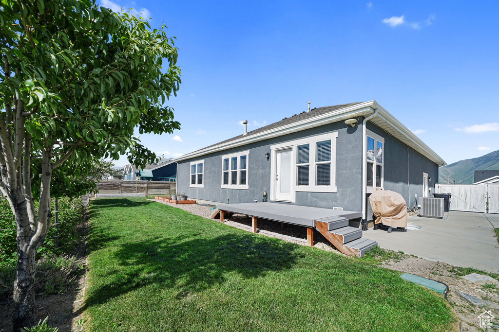 Back of house with central AC unit