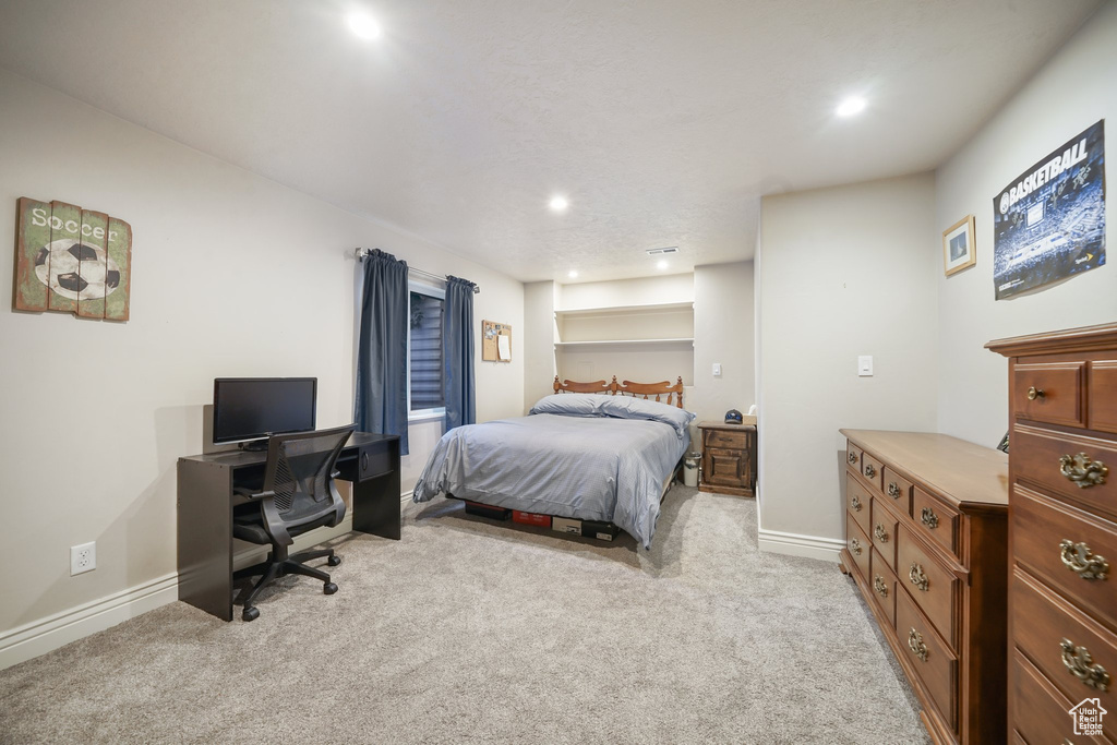 Bedroom featuring light carpet, an office area, baseboards, and recessed lighting