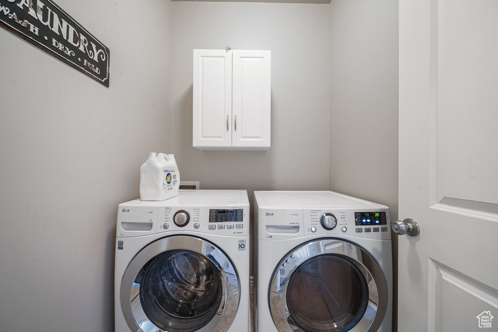Laundry room with washing machine and dryer and cabinet space
